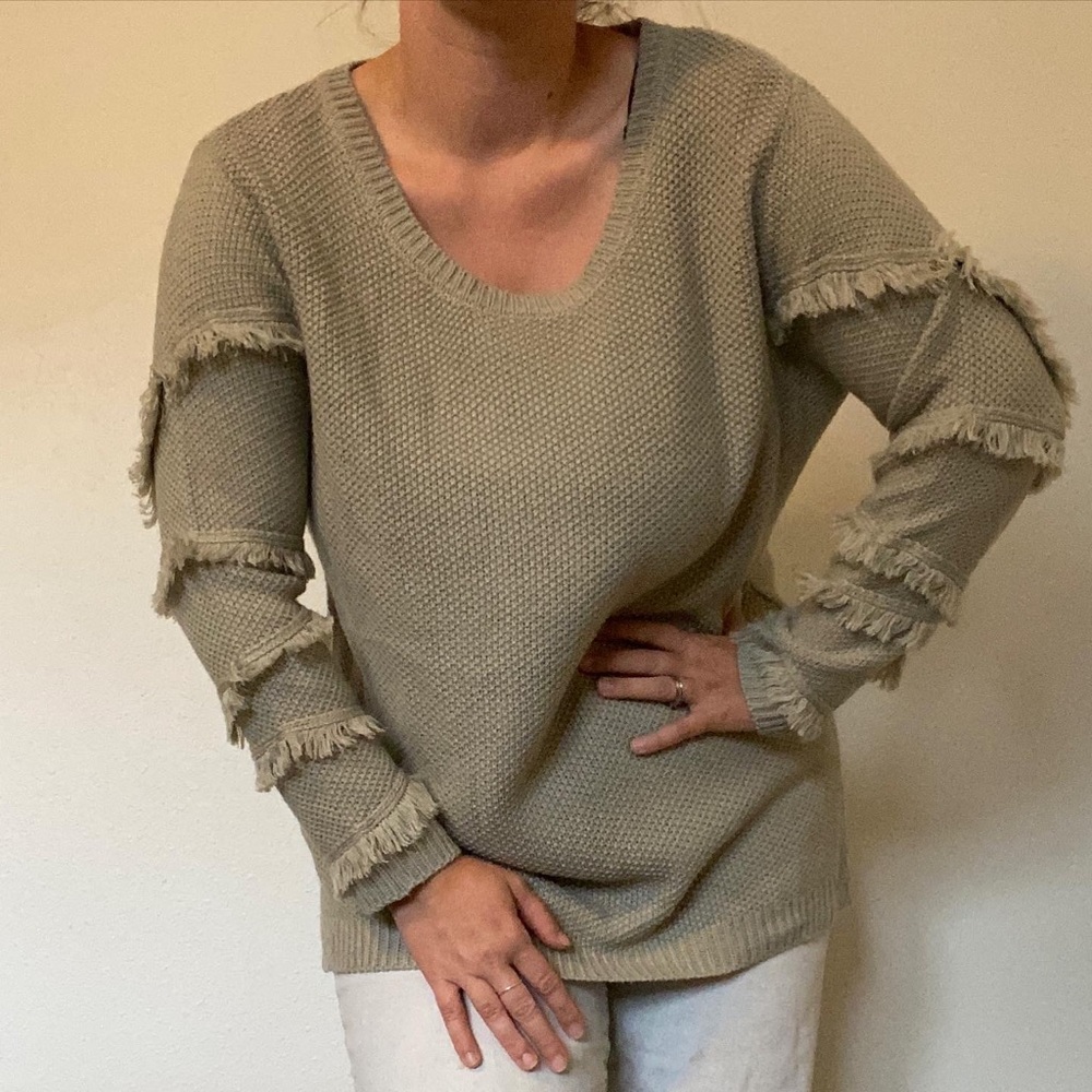 Comfy boho sweater with fun arm details. Perfect for those cold winter months.